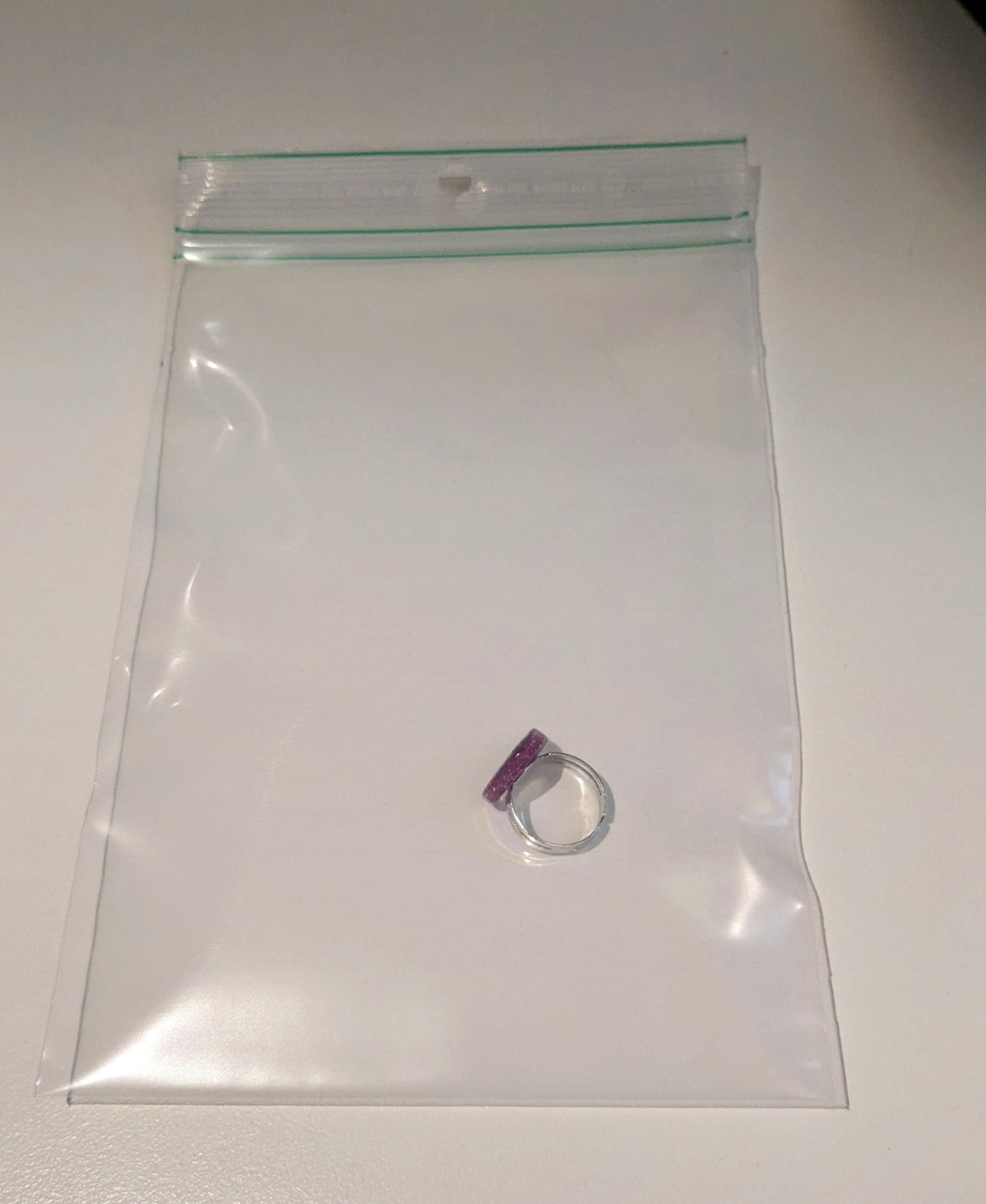 Wedding ring safely stored in transparent repair bag